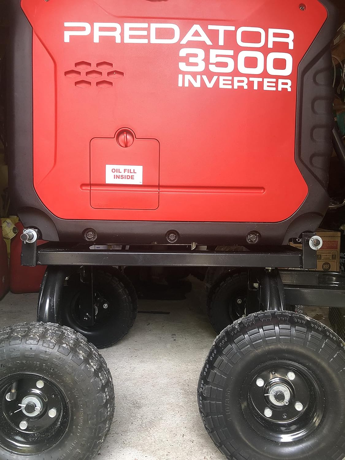 Red Predator 3500 Inverter generator with wheels on a concrete floor.
