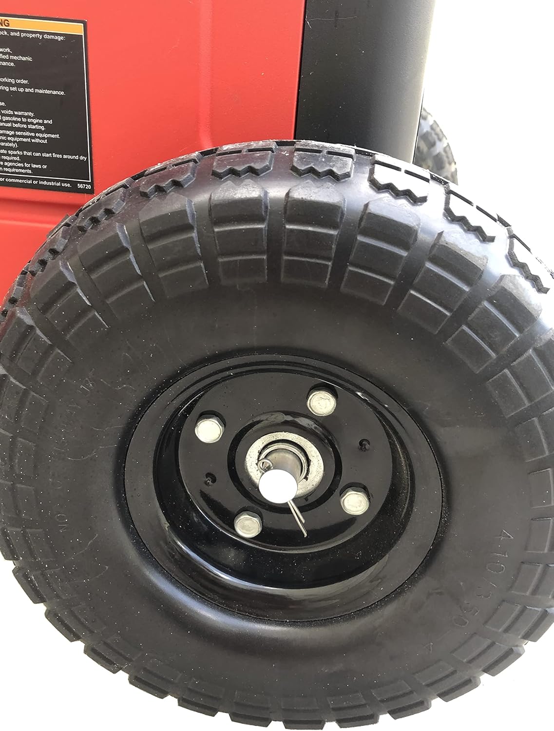Close-up of a black tire with a red background