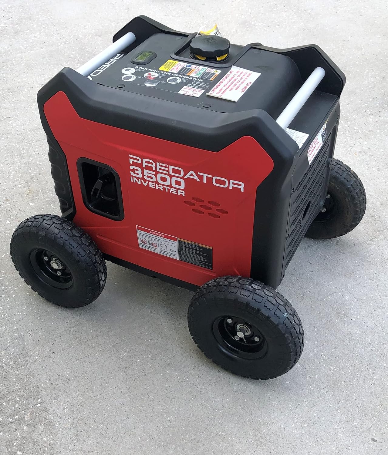 A red Predator 3500 Watt Inverter Generator with black wheels and text on the front panel.